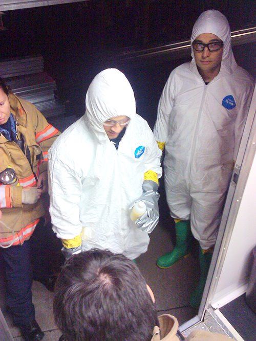 Two people standing while in hazmat suits